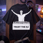 Trust The DJ Quote Oversized T-Shirt flat lay on wooden board DJ studio neon lights