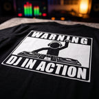Close up print detail of Warning DJ In Action Black Oversized T-Shirt DJ controller background
