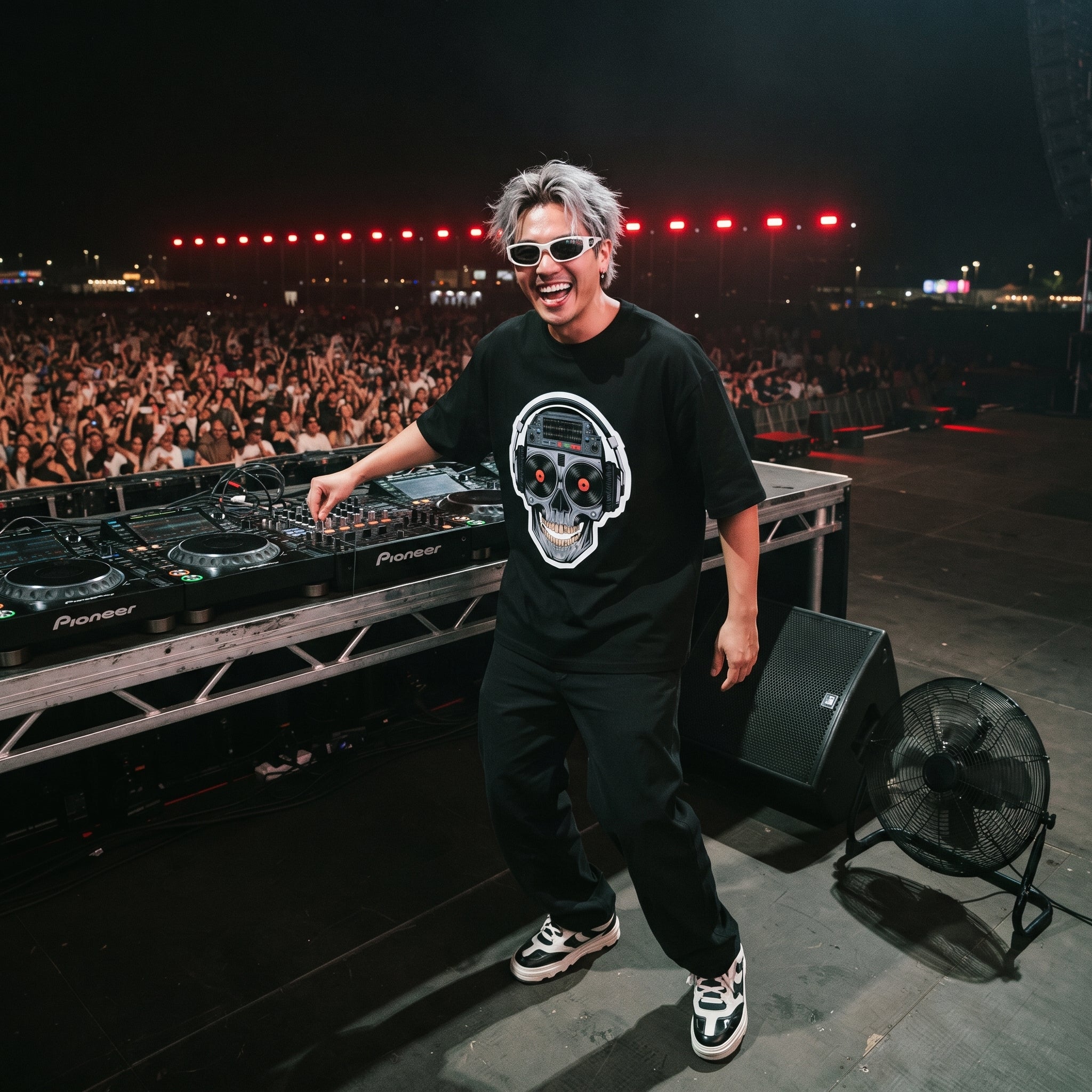 DJ in cyberpunk skull graphic oversized black t-shirt performing on outdoor festival stage in front of large crowd
