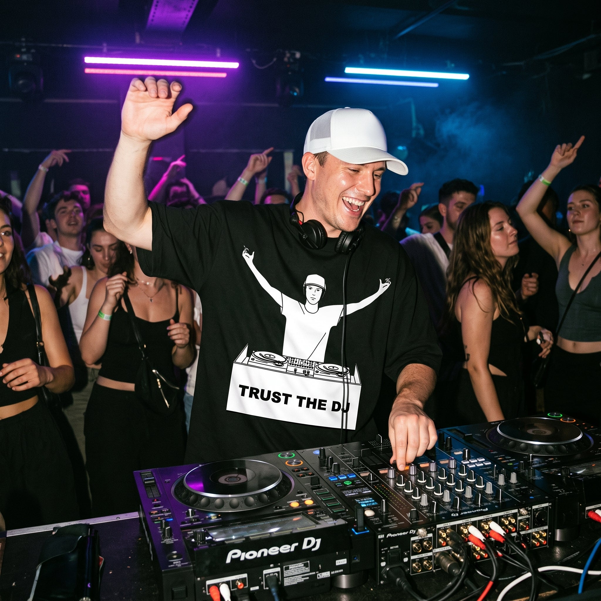 Male DJ wearing Trust The DJ Quote Oversized T-Shirt performing in club hand raised