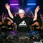 DJ wearing DJing Is An Art oversized t-shirt performing on Pioneer decks in front of cheering club crowd