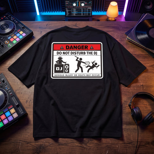 Danger DJ Do Not Disturb Black Oversized T-Shirt flat lay on DJ studio table vinyl records