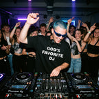 Male DJ in God's Favorite DJ Quote Black Oversized T-Shirt packed club blue hair sunglasses