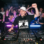 Male DJ in Warning DJ In Action Black Oversized T-Shirt performing in club fist raised