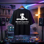 Black oversized DJ t-shirt with "World's Best DJ" quote print, worn on a hanger in a DJ studio setup.