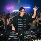 Female DJ wearing BPM Chart Oversized T-Shirt performing in nightclub with crowd
