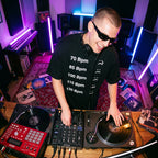 Male DJ in BPM Chart Oversized T-Shirt during live studio DJ session top angle