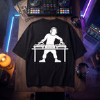 DJ Turntable Graphic Oversized T-Shirt flat lay on DJ studio table with headphones