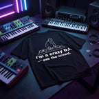 I'm A Crazy DJ Quote Black Oversized T-Shirt flat lay on music studio desk with synth neon lights