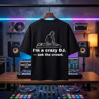 "I'm A Crazy DJ" bold quote print on a pitch-black oversized festival tee.