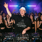 DJ wearing I'm A Crazy DJ Quote Oversized T-Shirt performing in club hand raised white cap