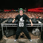 Official DJ Oversized T-Shirt worn by DJ performing on stage in front of massive festival crowd