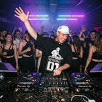 Official DJ Oversized T-Shirt in black worn by male DJ performing live at nightclub party with Pioneer DJ controllers